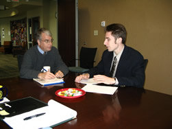 Alex Lipka discusses STATCOM's findings with Nick Schenkel of the West Lafayette Public Library.